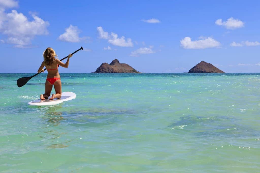 girl in bikini on a paddle board in hawaii