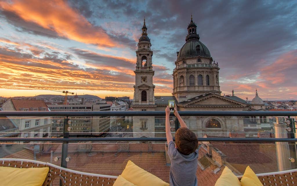 Kid-friendly Europe: Overlooking St. Stephen's Basilica from the rooftop patio of the Aria Hotel Budapest