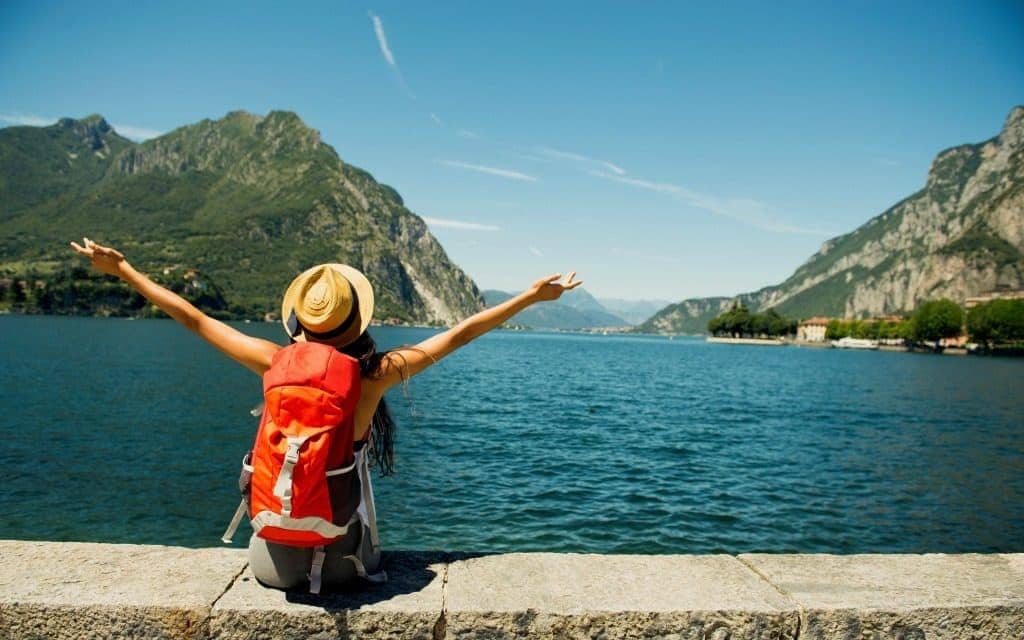 solo travel tips - female traveler overlooking lake