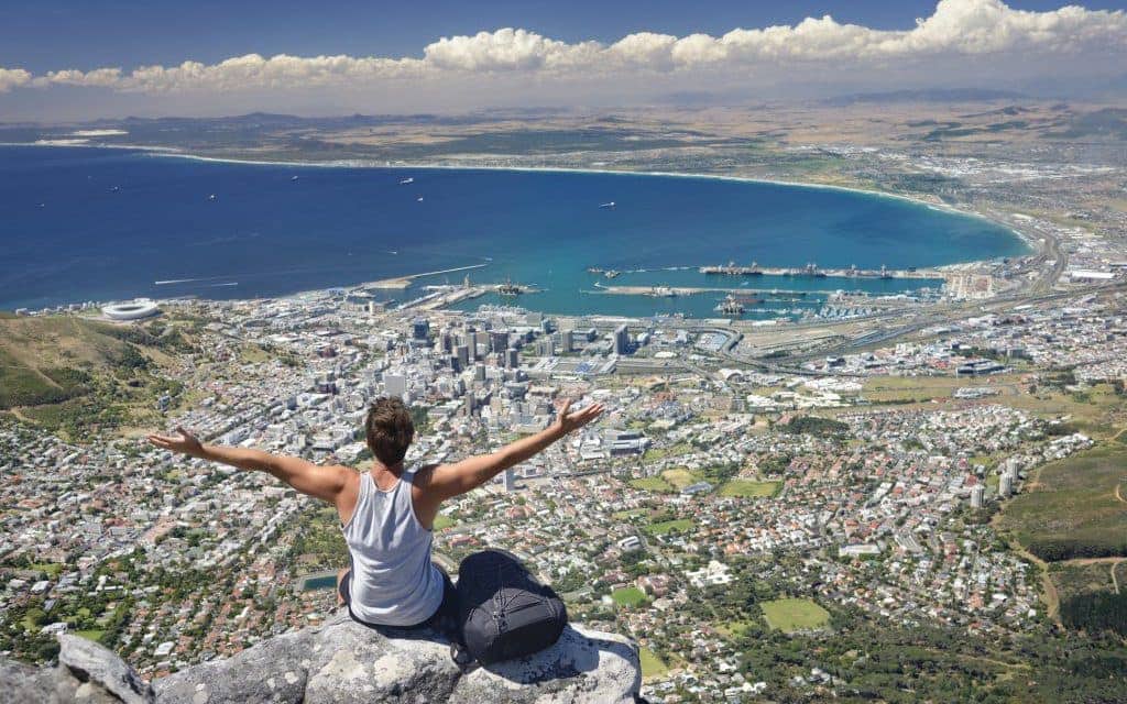 Tourist Hiker on Table Mountain overlooking Cape Town, South Africa.