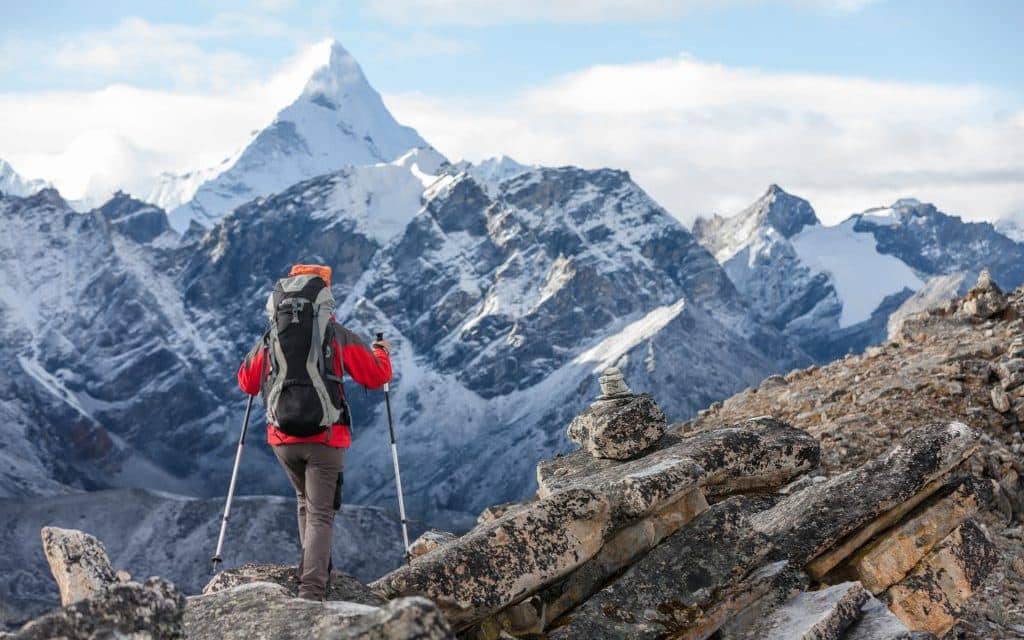 Hiker walks on train in Himalayas