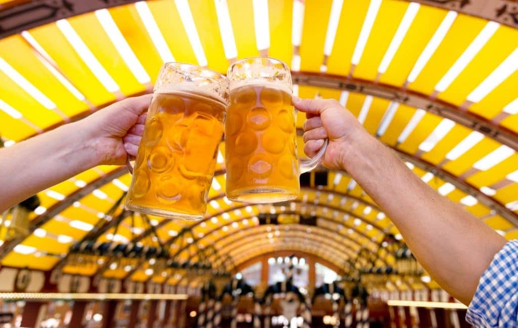 Two people clinking beer glasses at the Oktoberfest