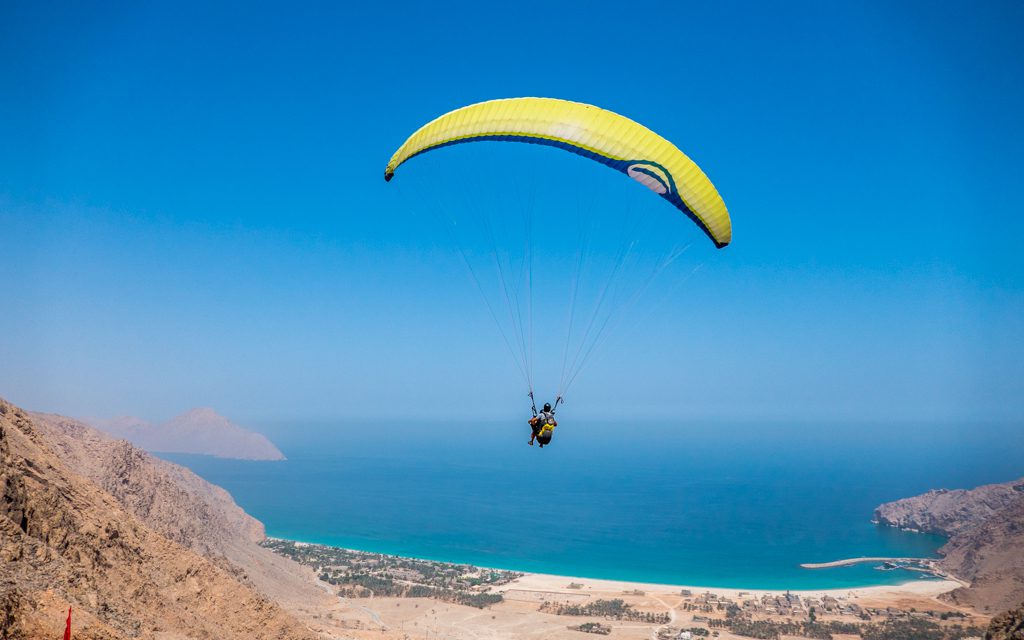 Amazing Hotel Arrivals - Paragliding to Six Senses Zighy Bay - taking off for the beach