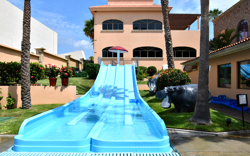 Blue water slides with hotel in background