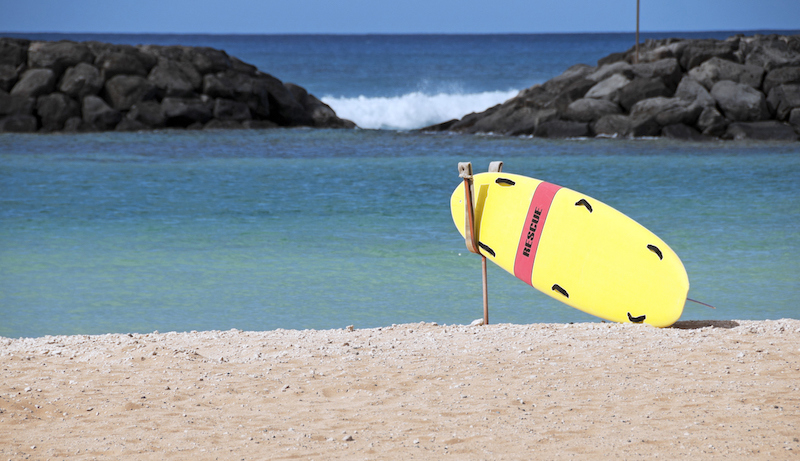 Lifeguard's rescue board on beach of lagoon at Ala Moana Beach Park in Honolulu