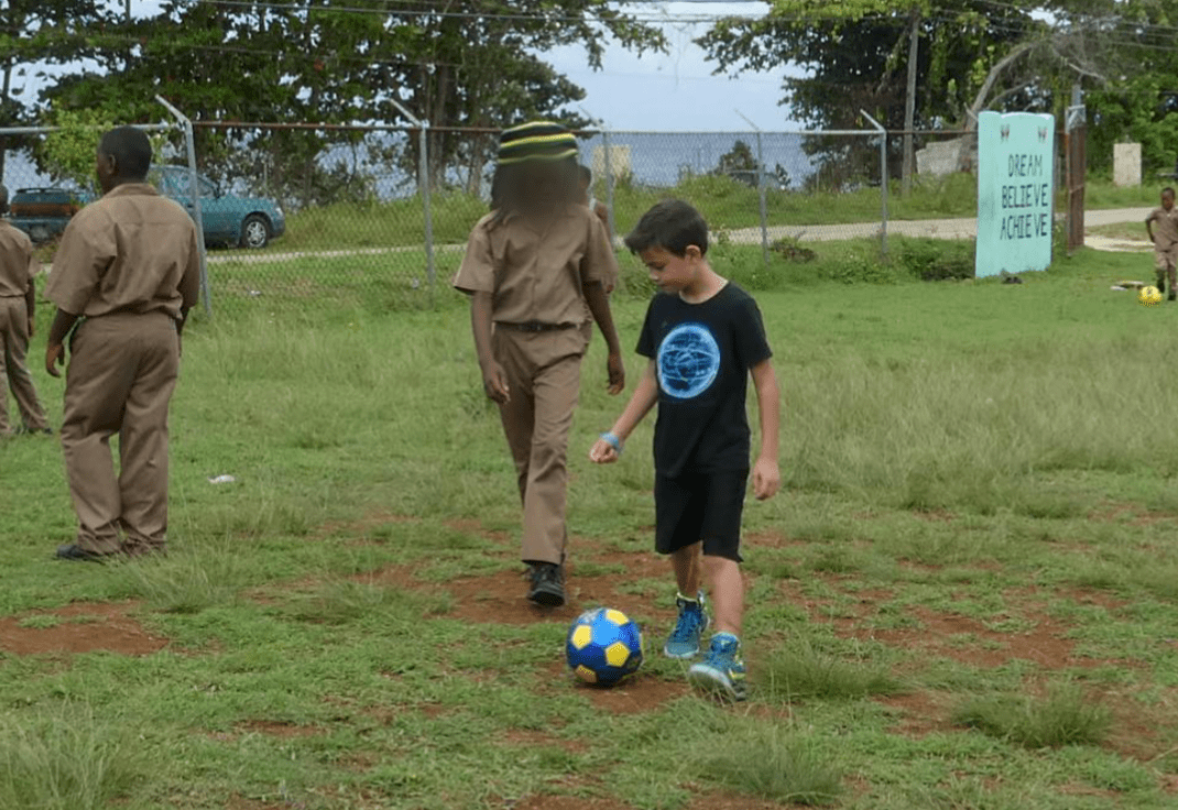 Jonah making new friends while volunteering at a school in Jamaica.