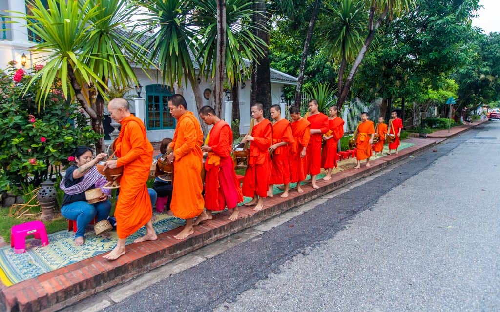World Tourism Day - Throughout Asia, monks go out at sunrise to accept donations of rice. We've woken up early in Laos and Thailand to donate.