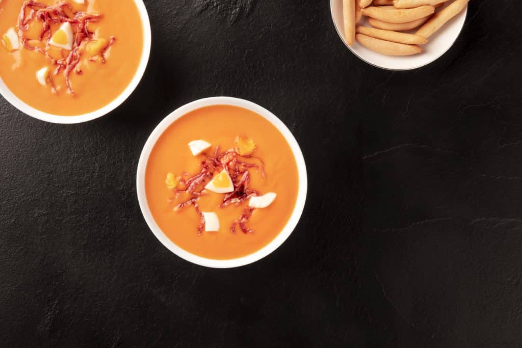 Salmorejo, Spanish cold soup, shot from above on a black background