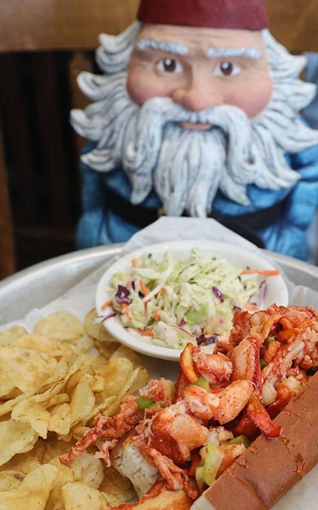 Roaming Gnome eating lobster roll