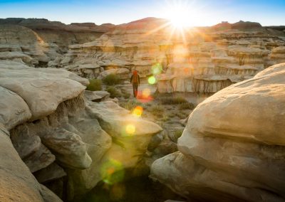 Backpacker Hiking In Hoodoo Wash In Bisti Badlands Wilderness Area New Mexico At Sunrise
