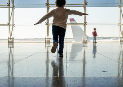 Mother playing with her kids at the airport